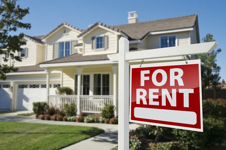 Left Facing Red For Rent Real Estate Sign in Front of Beautiful